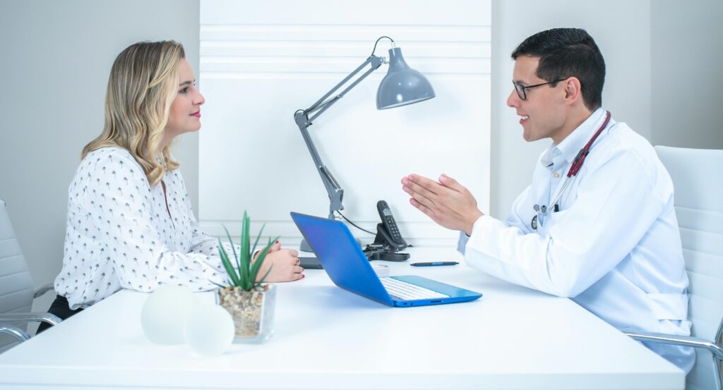 pexels photo 12599544 12599544 A doctor conducts a patient consultation in a bright, modern medical office.